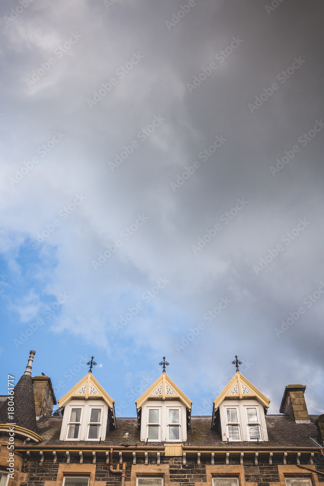 looking up to the rooftop windows of a typical old building in the town of grantown-on-spey in the scottish highlands