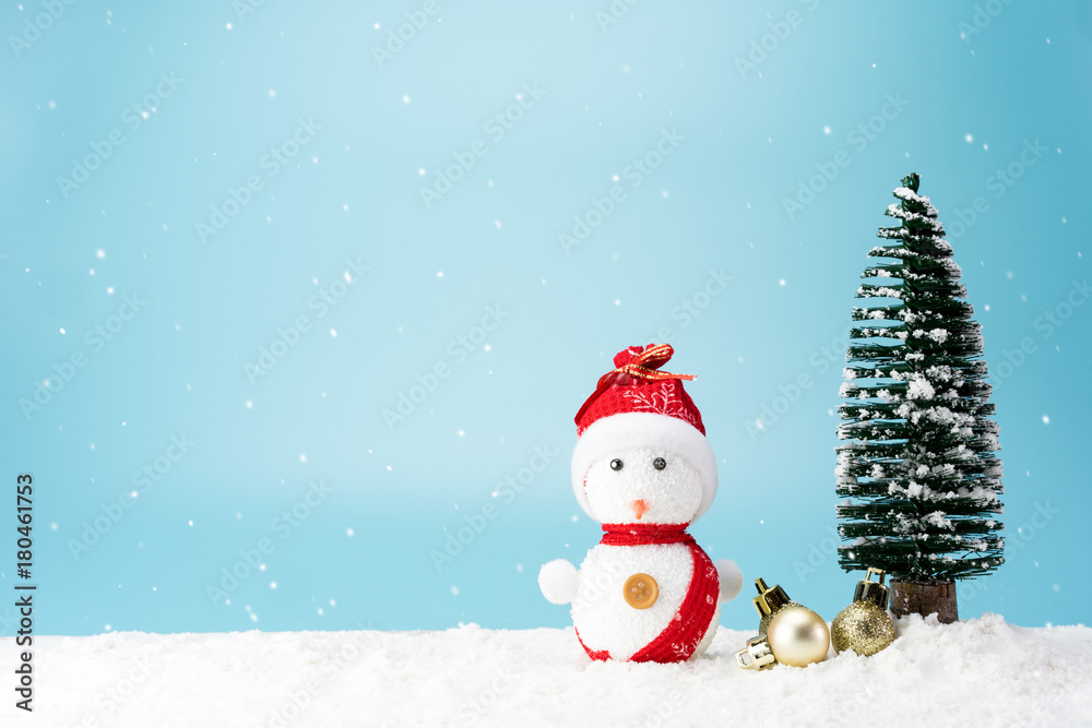Christmas tree and snowman on snow