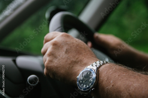 A man with both hands safely on the steering wheel, right hand drive united kingdom