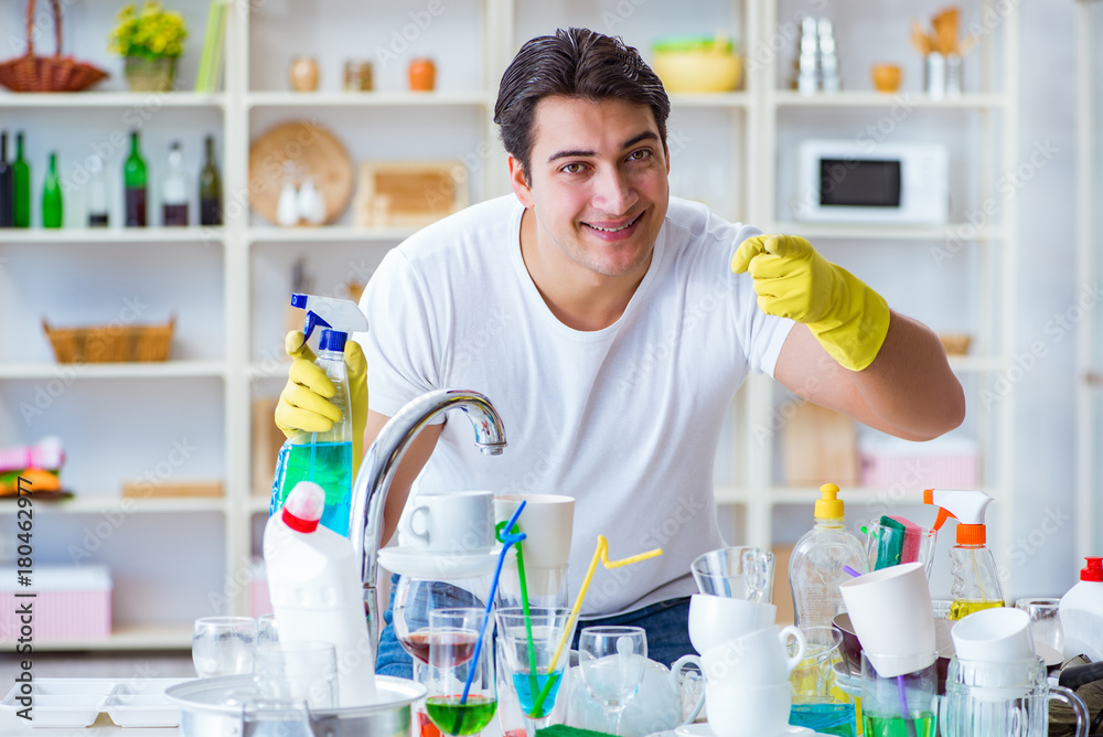 Man enjoying dish washing chores at home Man enjoying dish washing chores at home