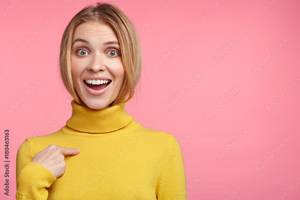 Look at my new sweater! Happy smiling female glad to buy new turtleneck sweater, points at herself, rejoices new purchase. Beautiful blonde female shop assistant advertises convinient clothes Look at my new sweater! Happy smiling female glad to buy new turtleneck sweater, points at herself, rejoices new purchase. Beautiful blonde female shop assistant advertises convinient clothes