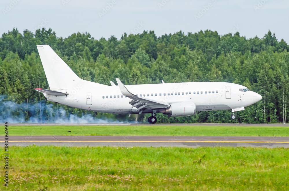 Airplane landing on the runway at the airport with smoke from the chassis. Hard landing. Airplane landing on the runway at the airport with smoke from the chassis. Hard landing.