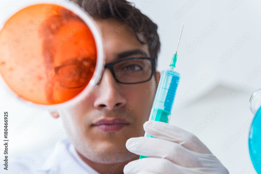 Chemist working in the laboratory with hazardous chemicals Chemist working in the laboratory with hazardous chemicals