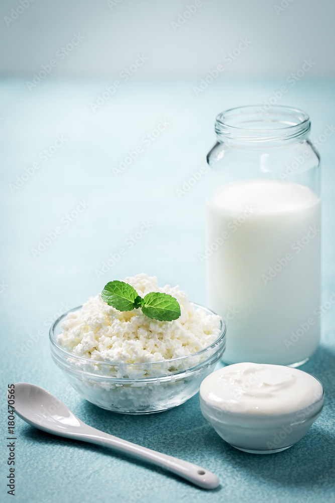 Raw fresh dairy products - milk, sour cream, yogurt, cottage cheese. Selective focus, copy space. Raw fresh dairy products - milk, sour cream, yogurt, cottage cheese. Selective focus, copy space.