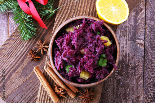 Fototapeta Naklejka Na Ścianę i Meble -  Red Cabbage salad with orange and pecan nuts for Christmas dinner. Vegetarian dish