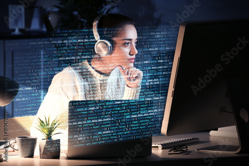 Young woman working with computer at table. Concept of cyber attack photo