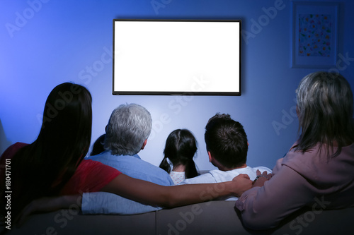 Family watching television at home. Leisure and entertainment concept.