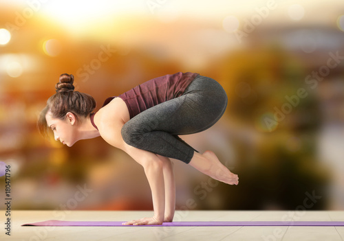 Young woman practicing yoga...