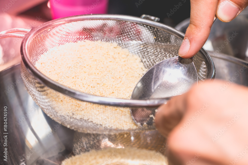 cook mixes and sieves almond powder in flour cook mixes and sieves almond powder in flour