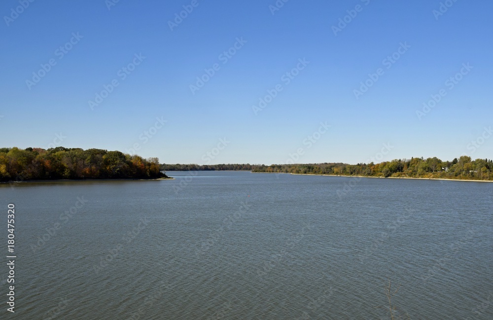 shoreline the Fanshawe reservoir lake lined with with colorful trees in Autumn , in London, Ontario Canada shoreline the Fanshawe reservoir lake lined with with colorful trees in Autumn , in London, Ontario Canada
