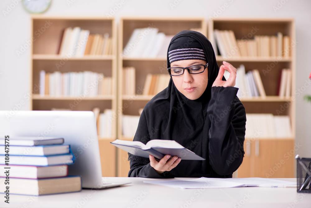 Muslim girl in hijab studying preparing for exams Muslim girl in hijab studying preparing for exams