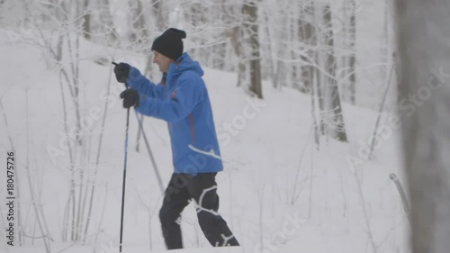 Two skiers gliding down a path enjoying themselves