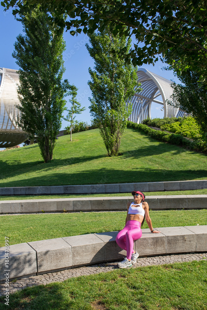 Obraz premium Fit middle-aged woman resting after training in park