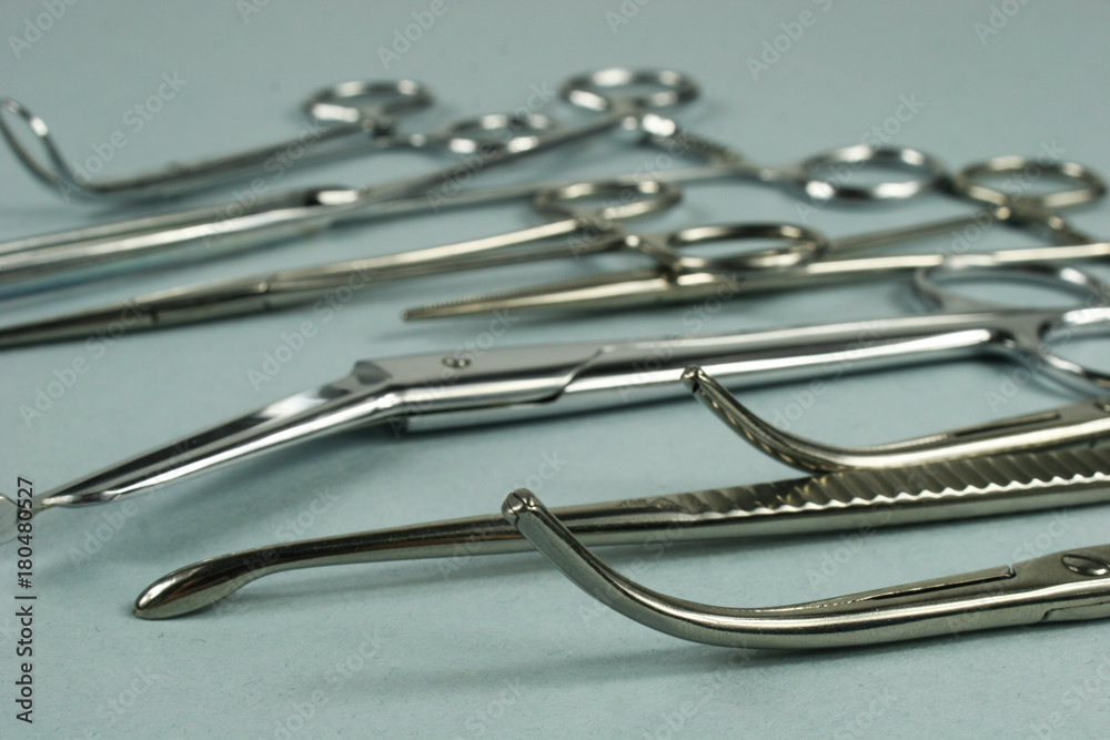 Medical surgical Instruments on blue background. Selective focus Medical surgical Instruments on blue background. Selective focus