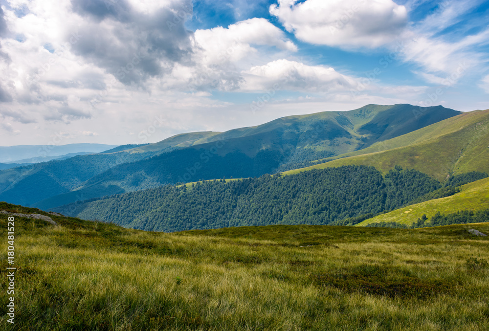 grassy slopes of mountain ridge under the cloudy sky. gorgeous summer nature scenery grassy slopes of mountain ridge under the cloudy sky. gorgeous summer nature scenery
