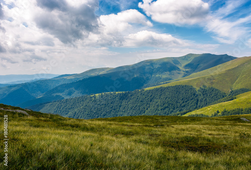 grassy slopes of mountain ridge under the cloudy sky. gorgeous summer nature scenery