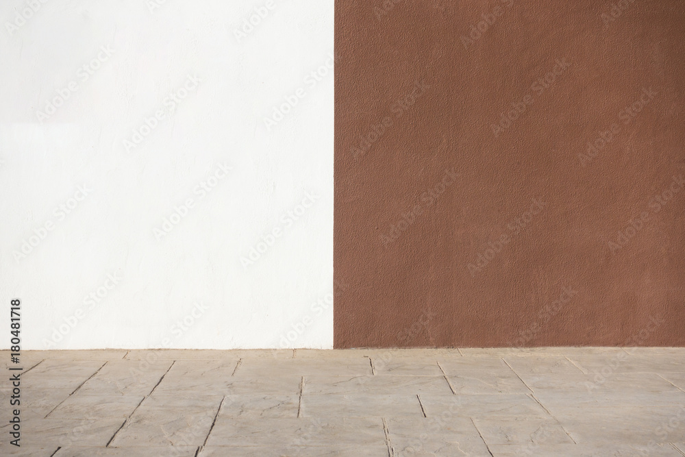 White and brown plastered wall and pavement as background White and brown plastered wall and pavement as background