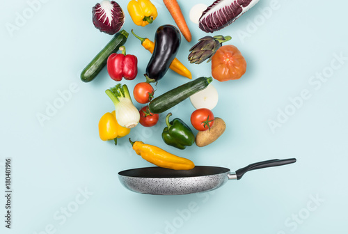 Fresh healthy vegetables falling in a pan