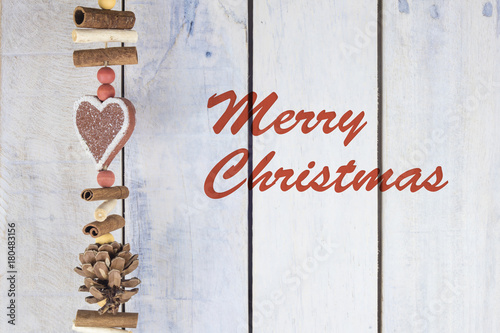 Christmas decoration on a wooden background with text in English "Merry Christmas"