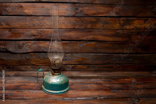 Old retro oil kerosene lamp on a wooden background