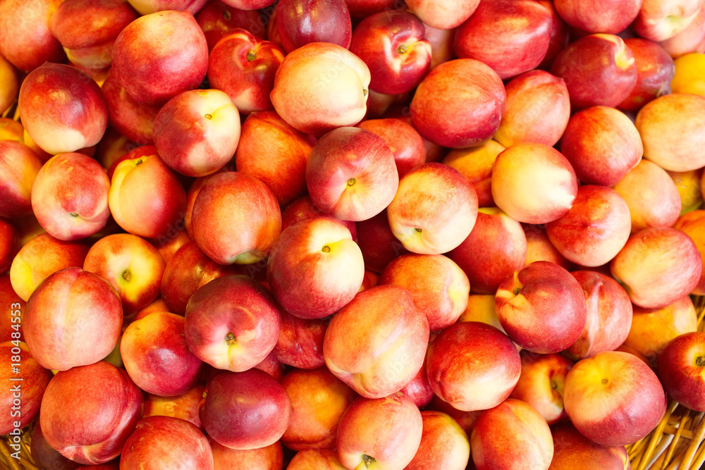 Nectarines in the store. A lot of nectarines close-up. Ripe nectarines. Selective focus Nectarines in the store. A lot of nectarines close-up. Ripe nectarines. Selective focus