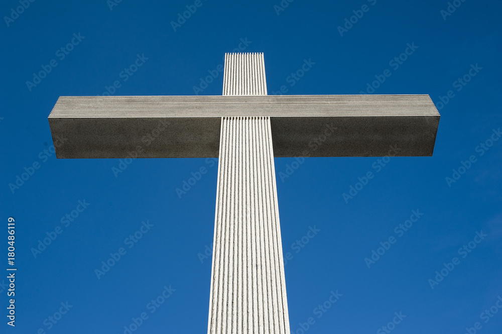 Catholic cross on the blue sky background