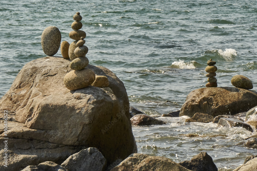 Stacked rocks with water in background Stacked rocks with water in background
