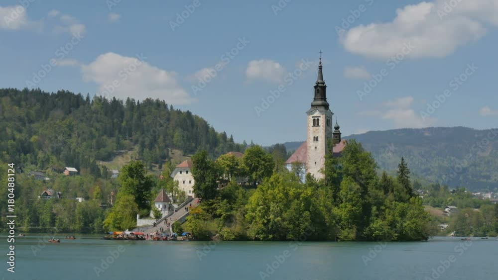 Island with Catholic Church at Bled Lake in Slovenia Alps 4K UHD Timelapse. Bled lake castle and island is an Iconic Slovenia Touristic place with terme and hotel where Tourists can rowing and boating Island with Catholic Church at Bled Lake in Slovenia Alps 4K UHD Timelapse. Bled lake castle and island is an Iconic Slovenia Touristic place with terme and hotel where Tourists can rowing and boating