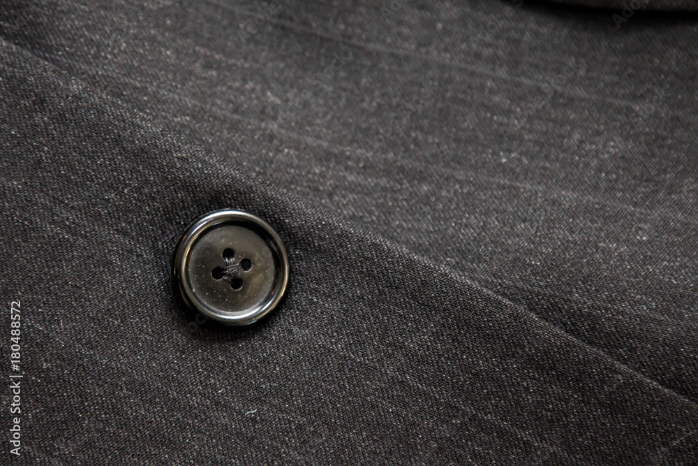 Plastic button on a gray pinstripe suit Plastic button on a gray pinstripe suit