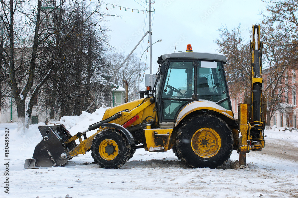 tractor for snow removal is parked on a city street tractor for snow removal is parked on a city street