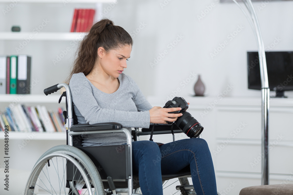 handicapped female photographer takes images with dslr camera