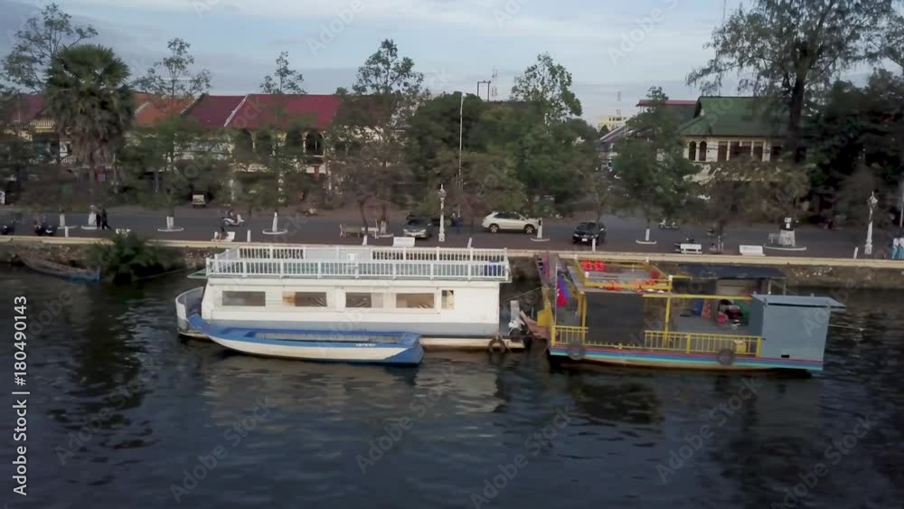 Aerial view of the Kampot, Cambodia, riverfront with tourist sunset cruise dining boats along the old chinese section of town on the Prek Kampong river. Aerial view of the Kampot, Cambodia, riverfront with tourist sunset cruise dining boats along the old chinese section of town on the Prek Kampong river.