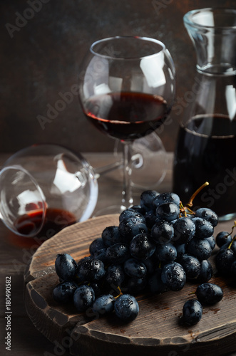 Fresh Black Grapes and Red Wine on Wooden Table Selective Focus