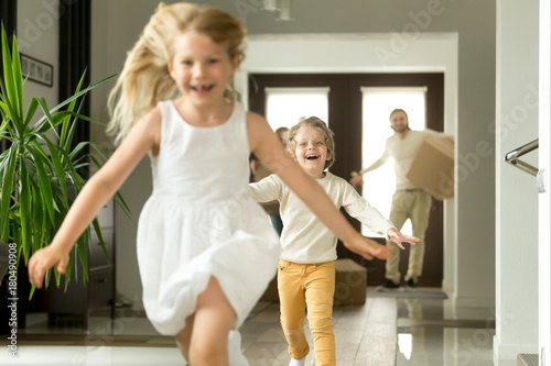 Fotografi Excited children running on camera, funny little girl and boy having fun playing