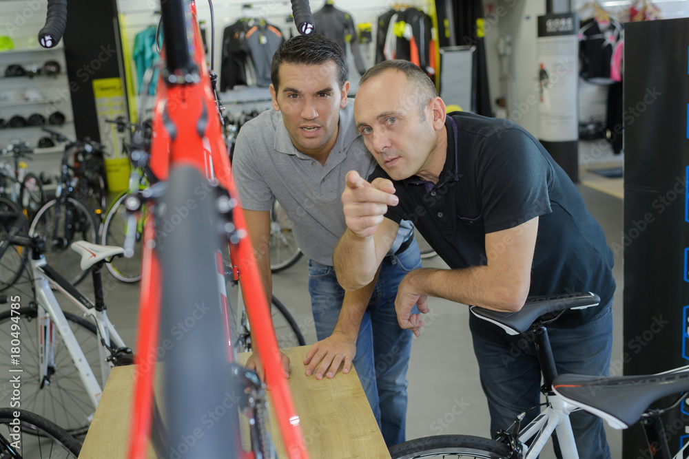 2 men in bike shop 2 men in bike shop