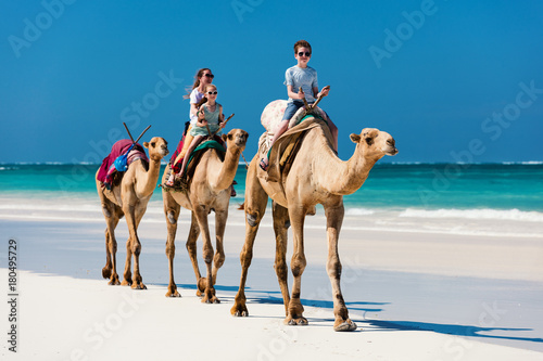 Mother and kids at tropical beach photo