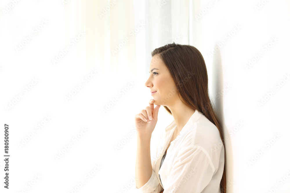 Profile of a woman thinking at home on white Profile of a woman thinking at home on white