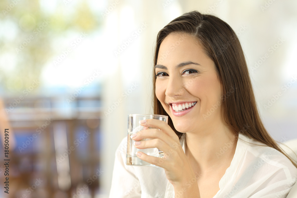 Happy woman holding a glass of water Happy woman holding a glass of water
