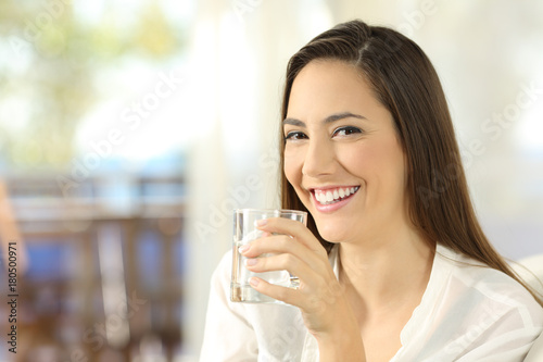 Happy woman holding a glass of water