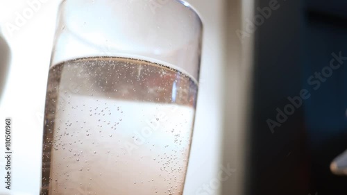 Old Glass of Water on bedstand developing stale flat bubbles photo