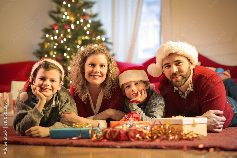 Cheerful family wearing Christmas hats