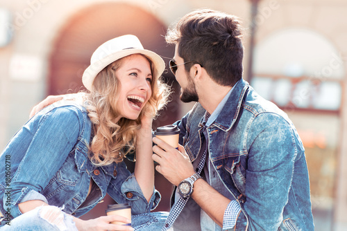 Bilde på lerret Beautiful young couple enjoying the sun with coffee to go.