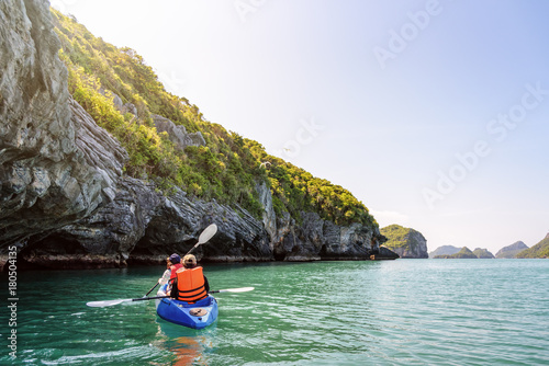 Two women are mother and daughter. Travel by boat with a kayak under sunlight at summer around Ko Phi beautiful nature of the sea and island, Mu Ko Ang Thong National Park, Surat Thani, Thailand