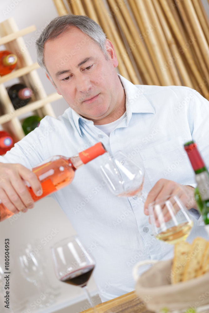 winemaker pouring wine to the glass in the wine cellar winemaker pouring wine to the glass in the wine cellar