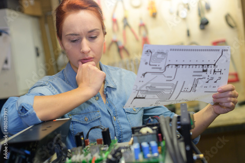 female puzzled in front of electronic parts