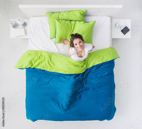 Woman waking up in her bed