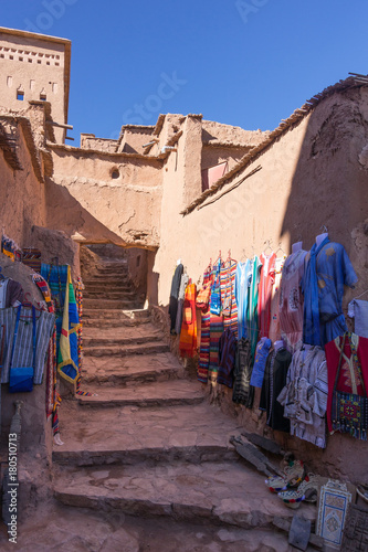 Colorful moroccan dress for sale in a alley of Ait Ben Haddou kasbah, Morocco © Francesco Bonino