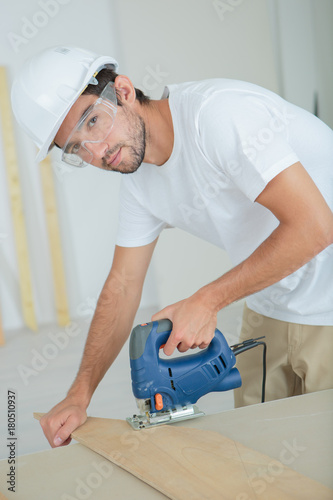 Man using electric jigsaw