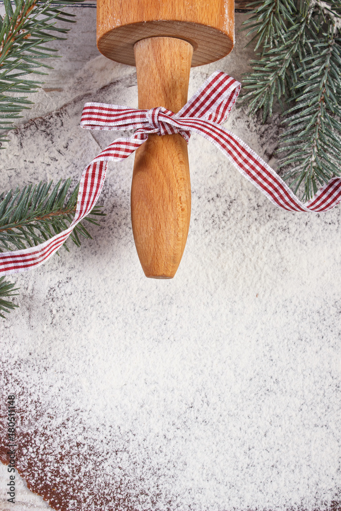 Rolling pin and dough for Christmas cookies or festive gingerbread