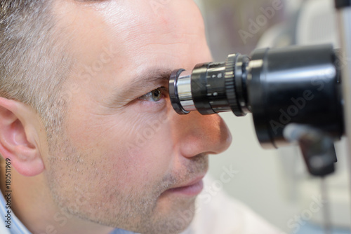optometrist performing visual field test